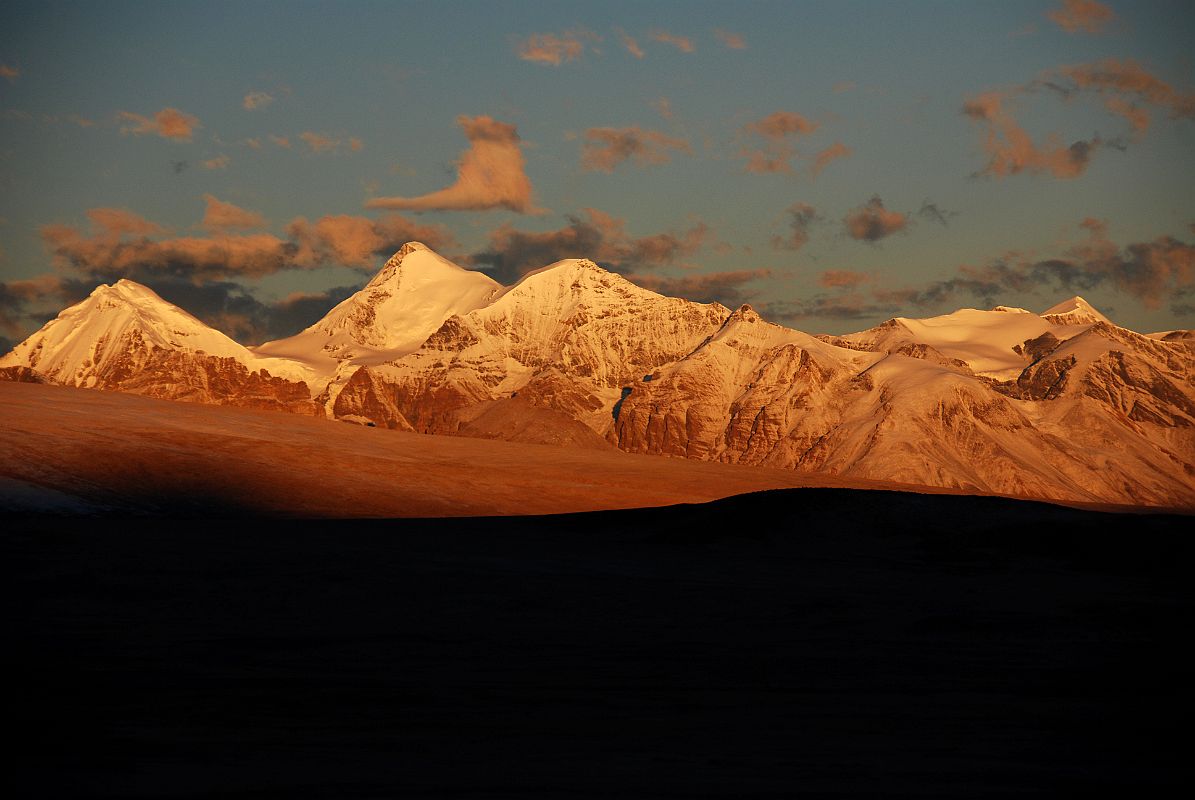 18 Chalung Ri Shines At Sunrise From Shishapangma North Base Camp The mountains around Chalung Ri (6767m) simply glow at sunrise from Shishapangma North Chinese Base Camp. Chalung Ri is the tall triangular peak in the left middle of the photo.